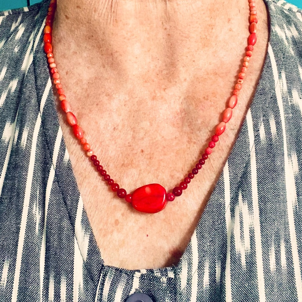 Coral necklace with silver beads.